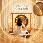 Person sitting in a room with a large gong in a gong bath session Golden Age Gong Bath
